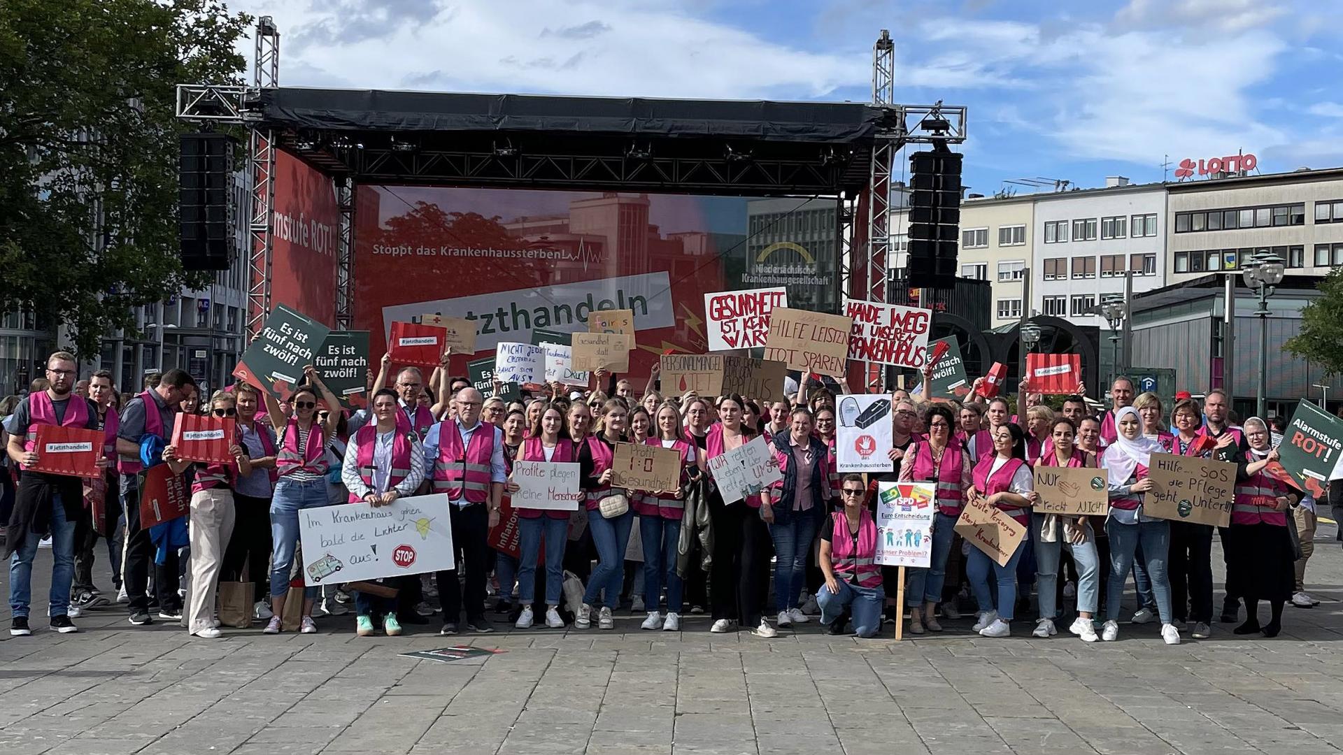 Mehrere Menschen zeigen Protestplakate in die Kamera